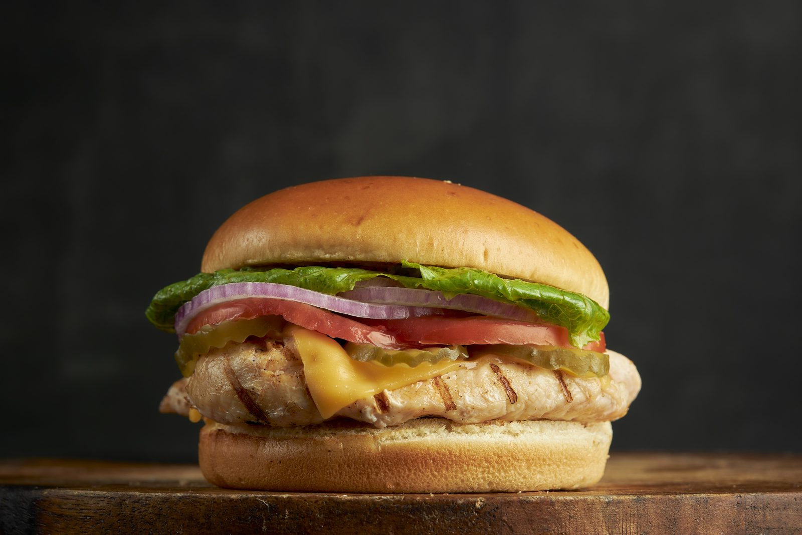Grilled chicken sandwich with lettuce, tomato and melted cheese