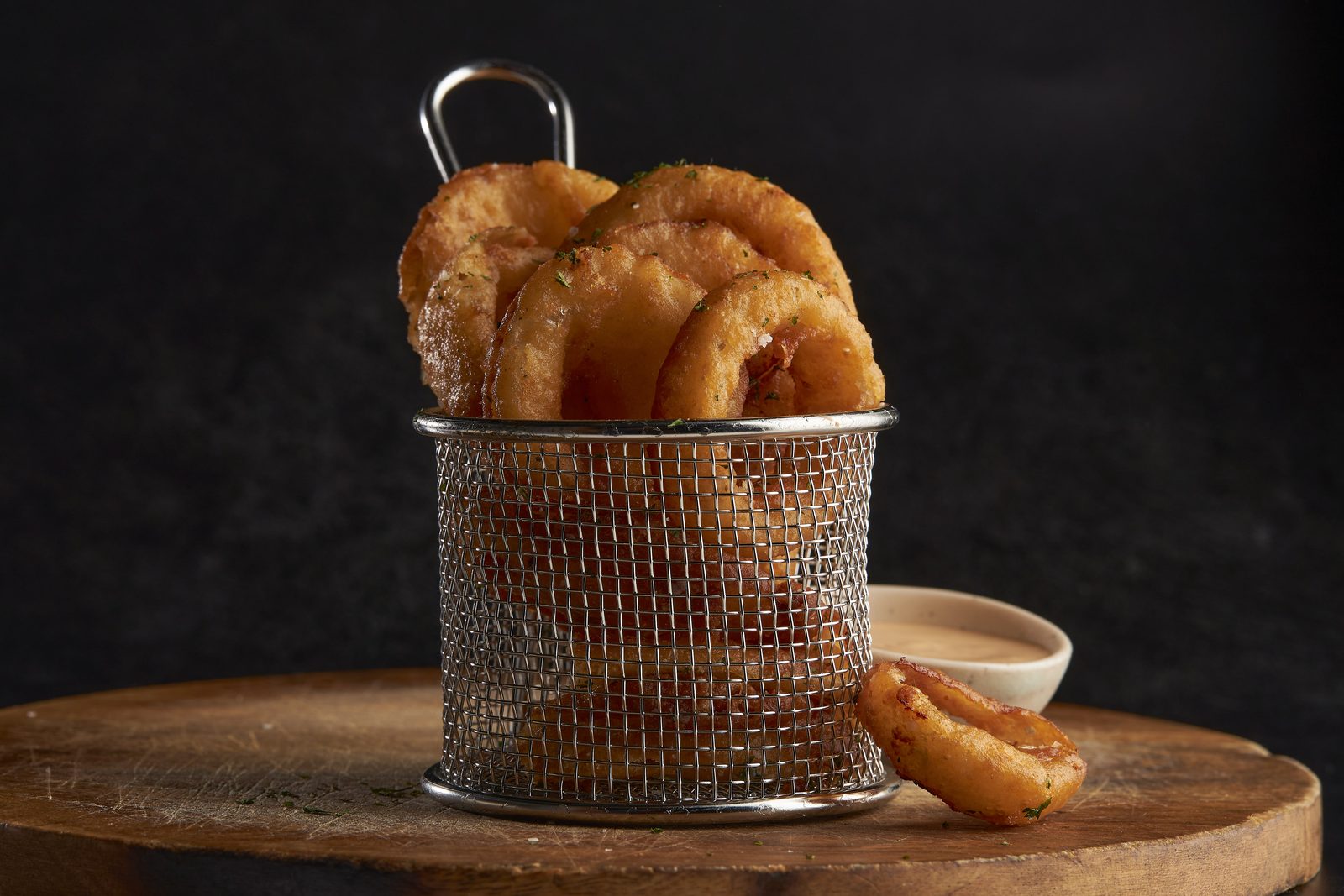Basket of hand-battered crispy onion rings