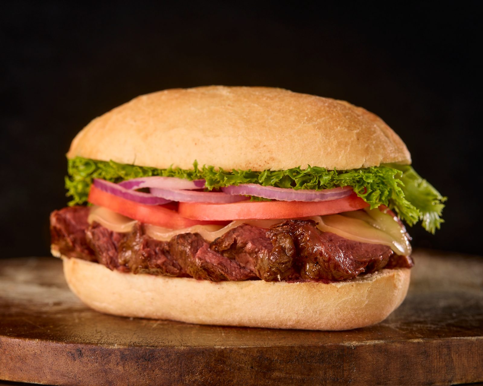 NY strip steak sandwich with lettuce and tomato