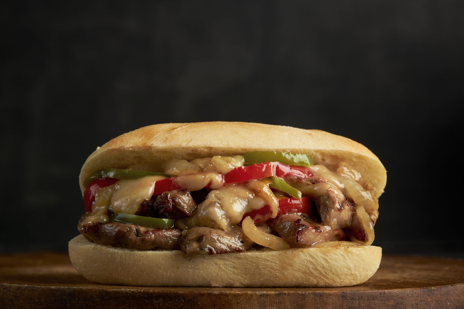 Philly style steak sandwich with sauteed onions, peppers and melted cheese