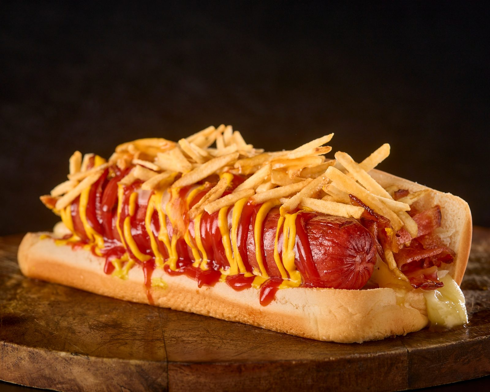 Colombian hot dog loaded with shoestring potatoes and sauces